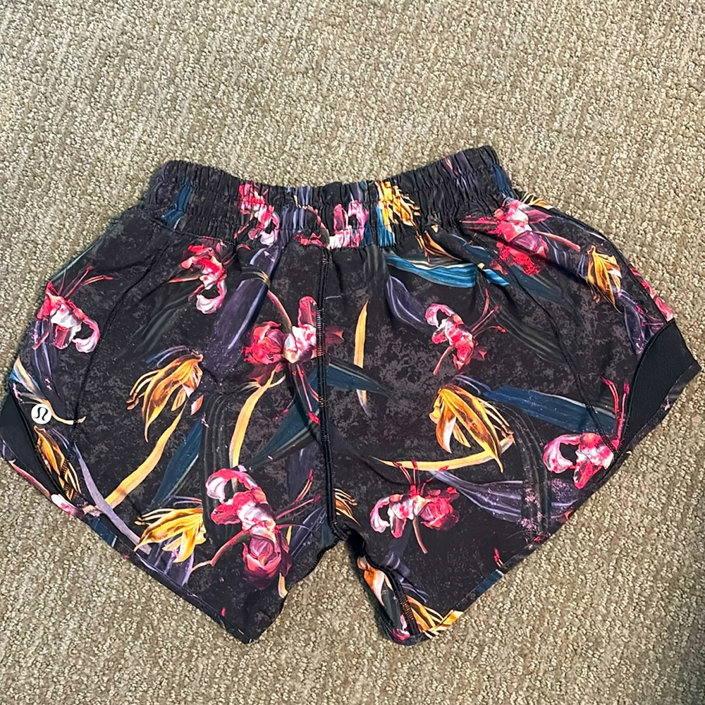 Lululemon Hottie Hot Low size 0 rise shorts 4” Black with orchid print.